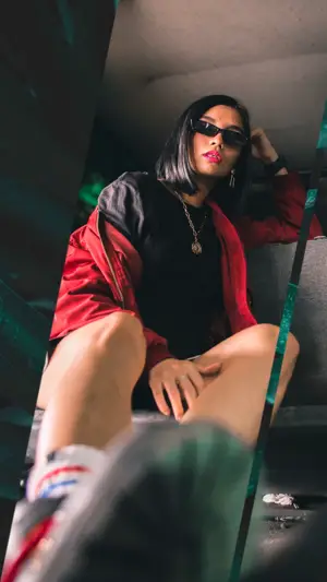 A Woman Sitting On Top Of A Chair Wearing Sunglasses Classy Template